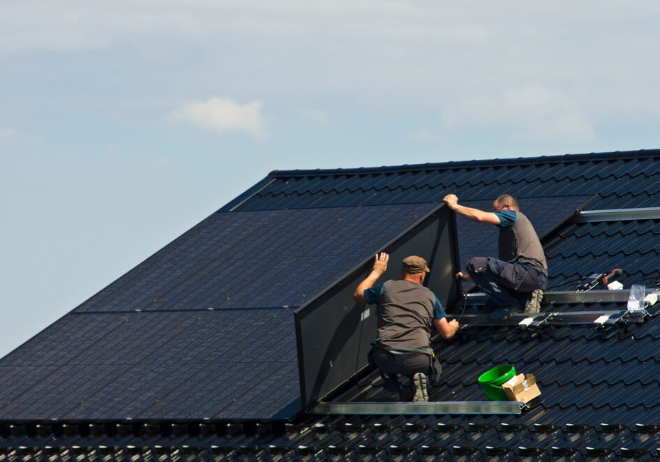 Installing,New,Black,Solar,Panels,On,The,Metal,Roof,Of